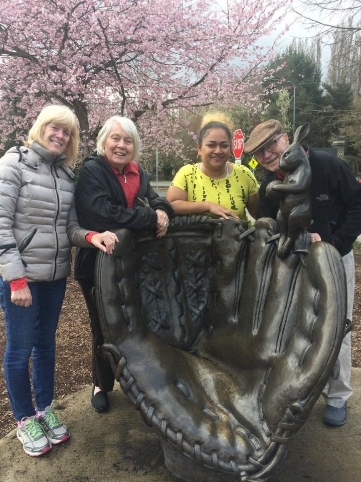 Group of People taking a picture of a huge baseball glove